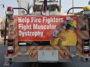 Sign on back of truck; "Help Fire Fighters Fight Muscular Dystrophy"