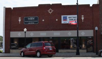 The building that once housed The Red Head Motor Company now houses a lawyers' office, realty company and a insurance agent.